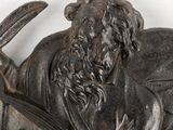 a statue of a man with a book and a dog