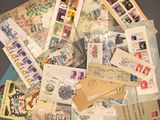 many different types of stamps and envelopes laid out on a table