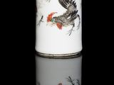 a white vase with a green lid on a black surface