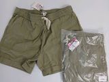 Le short est vert et comporte une étiquette blanche.