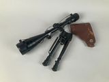 a close up of a rifle with a scope and other items