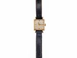 an image of a gold and black watch on a white background