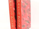 a red book with gold writing on the cover