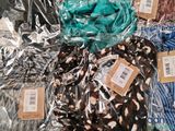many different types of clothing wrapped in plastic bags