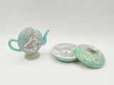 teapot with lid and saucer in the shape of a teapot