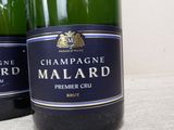 three bottles of champagne are lined up on a table