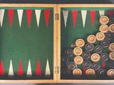 two wooden backgams in a box with different colored backgams