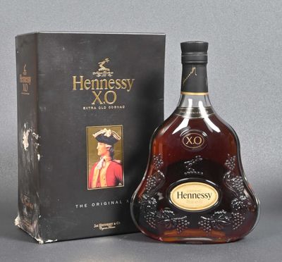 the bottle of hennessy xo is next to the box