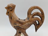 wooden rooster figurine with a tag on it ' s neck