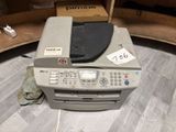 a printer sitting on top of a desk in a room