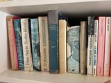 many books that are on a shelf in a book case
