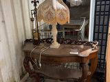 a table with a lamp on top of it in a room