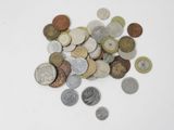 a pile of coins sitting on a white surface