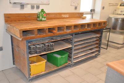 a wooden counter top with lots of bins on it