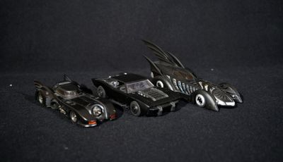 three toy cars that are sitting next to each other