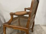an old wooden chair with a cane back and a cane seat