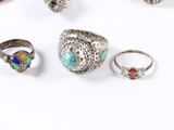 a group of silver rings and rings on a white surface