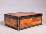 an old wooden box sitting on top of a white surface