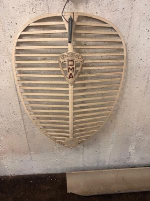 a wooden heart shaped sign hanging on the wall