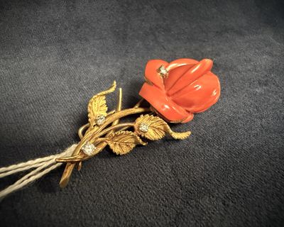 an image of a red flower brooch on a black background