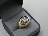 a ring in a box with a diamond inside of it