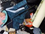 a bag full of clothes and other items on a bed