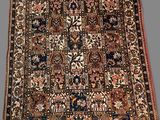 an antique persian rug with a floral design