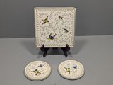 two small plates with birds on them sitting on a table
