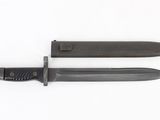 pair of knives on a white surface with a white background