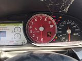 a car dashboard with a clock and a cell phone in it