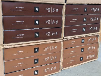 several cardboard boxes stacked on top of each other on a sidewalk