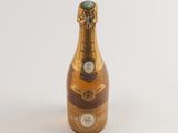 a bottle of champagne sitting on a white surface