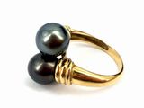 an image of a black pearl and gold ring on a white background