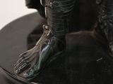 a statue of a man with a hat and boots