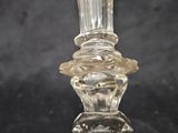 a clear glass vase with a clear base on a black surface