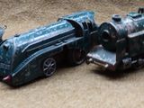 three toy trains that are sitting on the floor