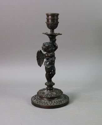 pair of bronze candlesticks with cherenshes and cherenshes on them