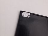 black leather wallet with a sticker on it sitting on top of a table