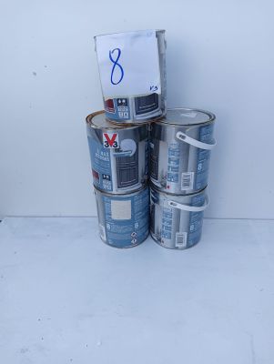 several cans of paint are stacked on top of each other