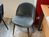 a chair in the corner of a room with a computer on it