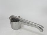 an image of a metal measuring spoon with a handle on a white surface