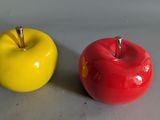 two apples sitting next to each other on a table