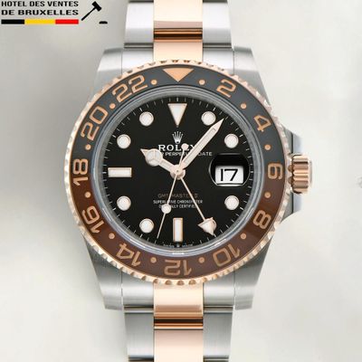 rolex watch with a black dial and two tone bracelet