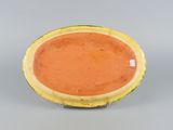 an orange and yellow plate sitting on top of a table
