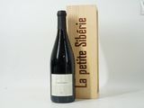 a bottle of wine sitting next to a wooden box