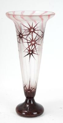 a glass vase that has a star design on it