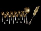 many spoons and spoons that are on a black surface
