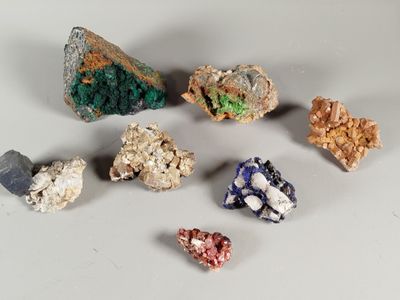 a lot of different colored rocks on a white surface