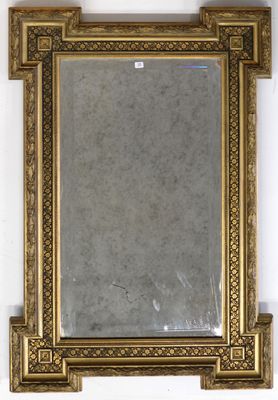 a mirror hanging on the wall with a gold frame