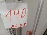 a hand that is holding a sign in front of a refrigerator